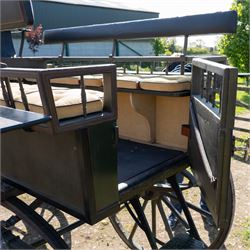 The Zetland Body Break by Peters & Sons, London

A fine and substantial late nineteenth century body break by Peters & Sons of London, circa 1880, formerly owned by the Marquis of Zetland. The carriage is finished in dark olive green and black with red, black and yellow lining, and is fitted with an elevated coachman’s box seat above a forward luggage compartment. The open rear body is entered by side doors and arranged with opposing longitudinal passenger seating.

The carriage is mounted on English pattern wooden artillery wheels with iron tyres and is carried on full elliptic springs, with a transverse helper spring behind. The front axle is fitted with fifth wheel turntable steering. The rear passenger compartment has upholstered longitudinal side benches beneath padded back rails, with turned spindle upper panels to the side doors and rear handrails. The driver’s seat is upholstered in corded fabric and secured with leather retaining straps.

Details include shaped splinter bar and turntable, folding rear step below the door with leather covered interior handle, luggage rails to either side, pole fittings for use with a pair or team of horses, and a handbrake with brake blocks operating to both rear wheels. The wheel hubs are fitted with polished hub caps engraved “Peters & Sons, London”. The exterior retains small Zetland family crests to the side panels.

The carriage has been conserved by Woods of Fairbourne Carriages Ltd and is recorded as Lot 146 in The George Shaw Collection sale, 5 November 2003, where it was catalogued as The Zetland Body Break and described as having previously been owned by the Marquis of Zetland.

Features
• Peters & Sons, London coachbuilder’s hub caps
• Known as The Zetland Body Break
• Formerly owned by the Marquis of Zetland
• Circa 1880
• Conserved by Woods of Fairbourne Carriages
• Dark olive green and black bodywork with red, black and yellow lining
• Elevated coachman’s box seat
• Forward luggage compartment
• Open rear passenger body with side doors
• Opposing longitudinal passenger seating
• Turned spindle upper panels to the side doors
• Folding rear step with leather covered interior handle
• Full elliptic spring suspension with transverse helper spring behind
• Fifth wheel turntable steering
• Handbrake with brake blocks operating to both rear wheels
• Wooden artillery pattern wheels with iron tyres
• Shaped splinter bar and pole fittings for a pair or team of horses
• Small Zetland family crests to the side panels

Provenance
The George Shaw Collection, 5 November 2003, Lot 146. Previously owned by the Marquis of Zetland.

Conservation

Conserved by Woods of Fairbourne Carriages.

Dimensions:
Overall length: 310 cm
Width: 176 cm
Height: 226 cm

Front wheel diameter: 98 cm
Rear wheel diameter: 140 cm

Seating:
Driver's box seat: 2 persons

Rear passenger compartment: Two longitudinal benches accommodating approximately 8 to 10 passengers