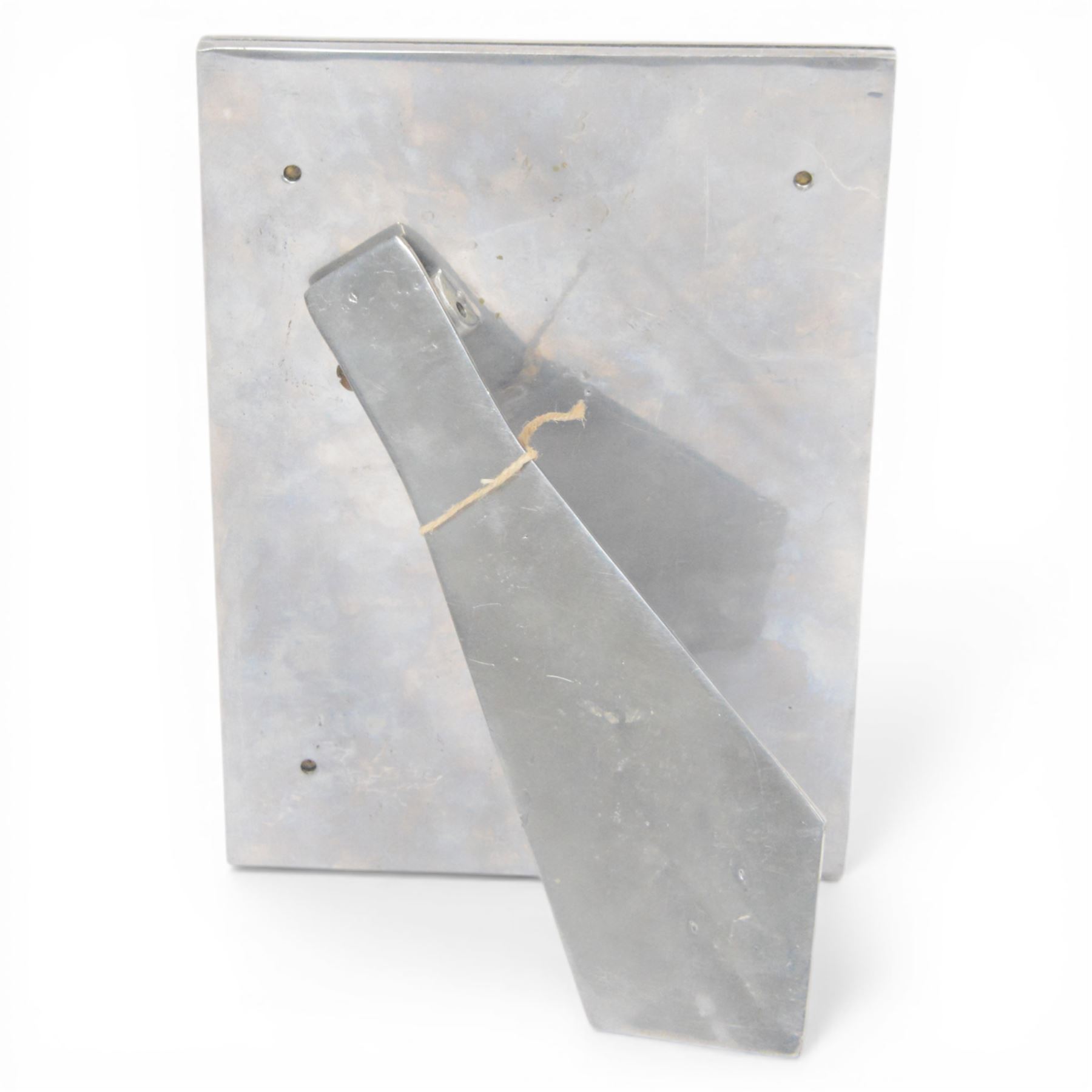 David Marshall photo frame, of cast aluminium mounted with a smaller brass frame, the maker's mark impressed to the lower left hand corner, H23cm