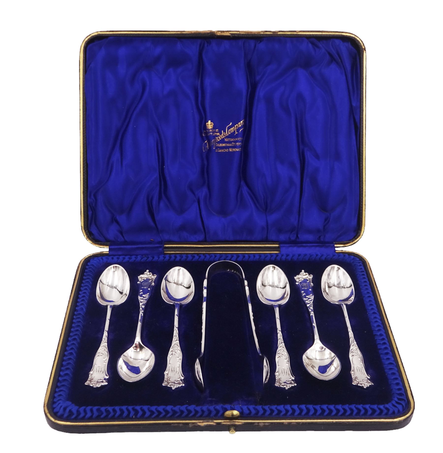 Edwardian silver cream jug, of fluted helmet form, with angular handle and upon shaped foot, hallmarked Birmingham 1905, maker's mark indistinct, together with a set of six Edwardian silver teaspoons and a pair of sugar tongs, all with scrolling embossed decoration and engraved monogram, hallmarked Joseph Rodgers & Sons, Sheffield 1903, within tooled leather fitted case, jug including handle H9cm 