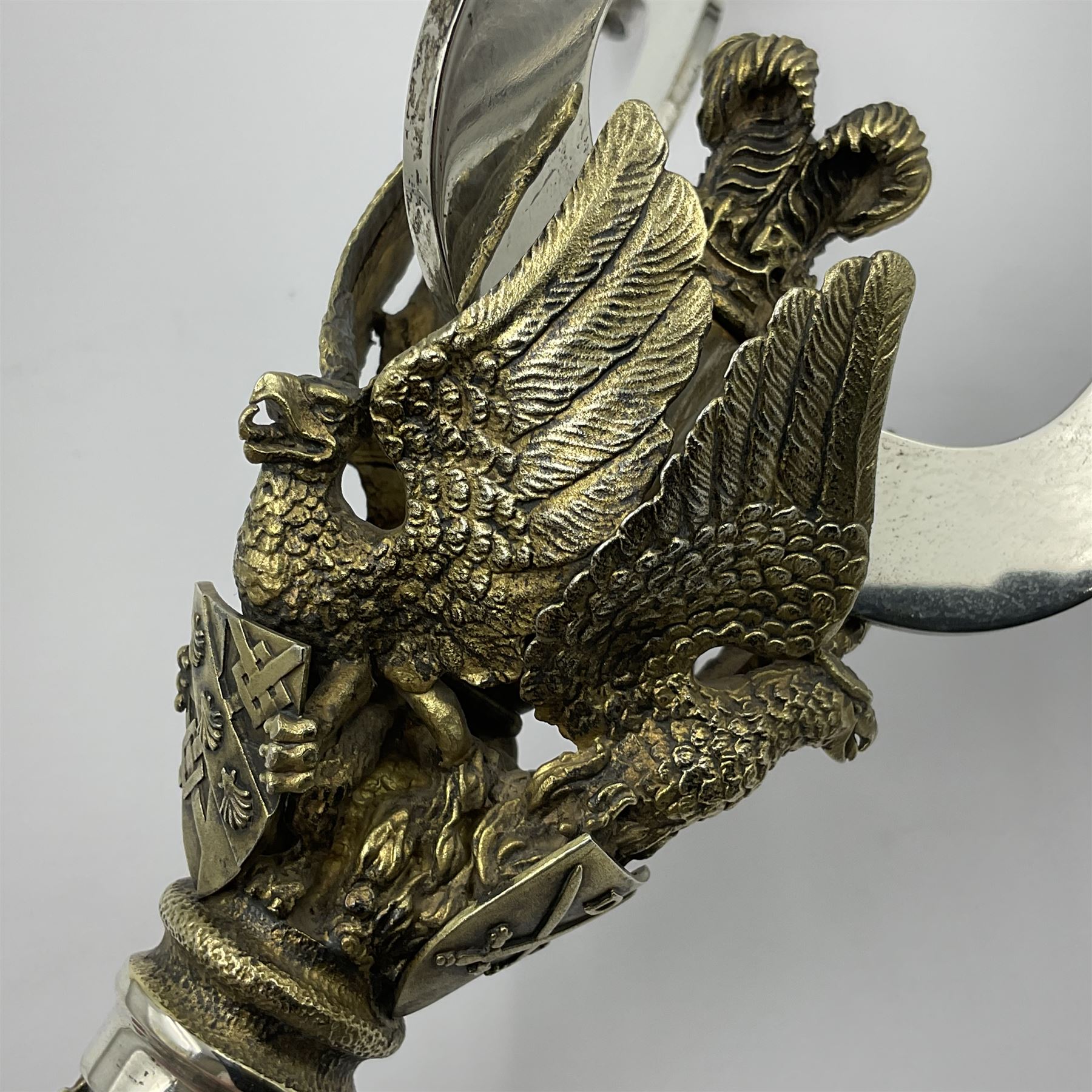 Pair of modern limited edition silver three branch candelabra, commemorating the marriage of HRH Prince Charles and Lady Diana Spencer, replicas of the St Paul's Cathedral candelabra, the three gilt branches each supporting a fluted candle holder and united by a crown containing the Prince of Wales feathers, upon a parcel gilt stem, with three griffins, each holding crested shields, above parcel gilt flower heads cascading to a ciruclar foot, limited edition no. 119 & 120/400, hallmarked Henry Miller for Aurum, London 1981, H22cm