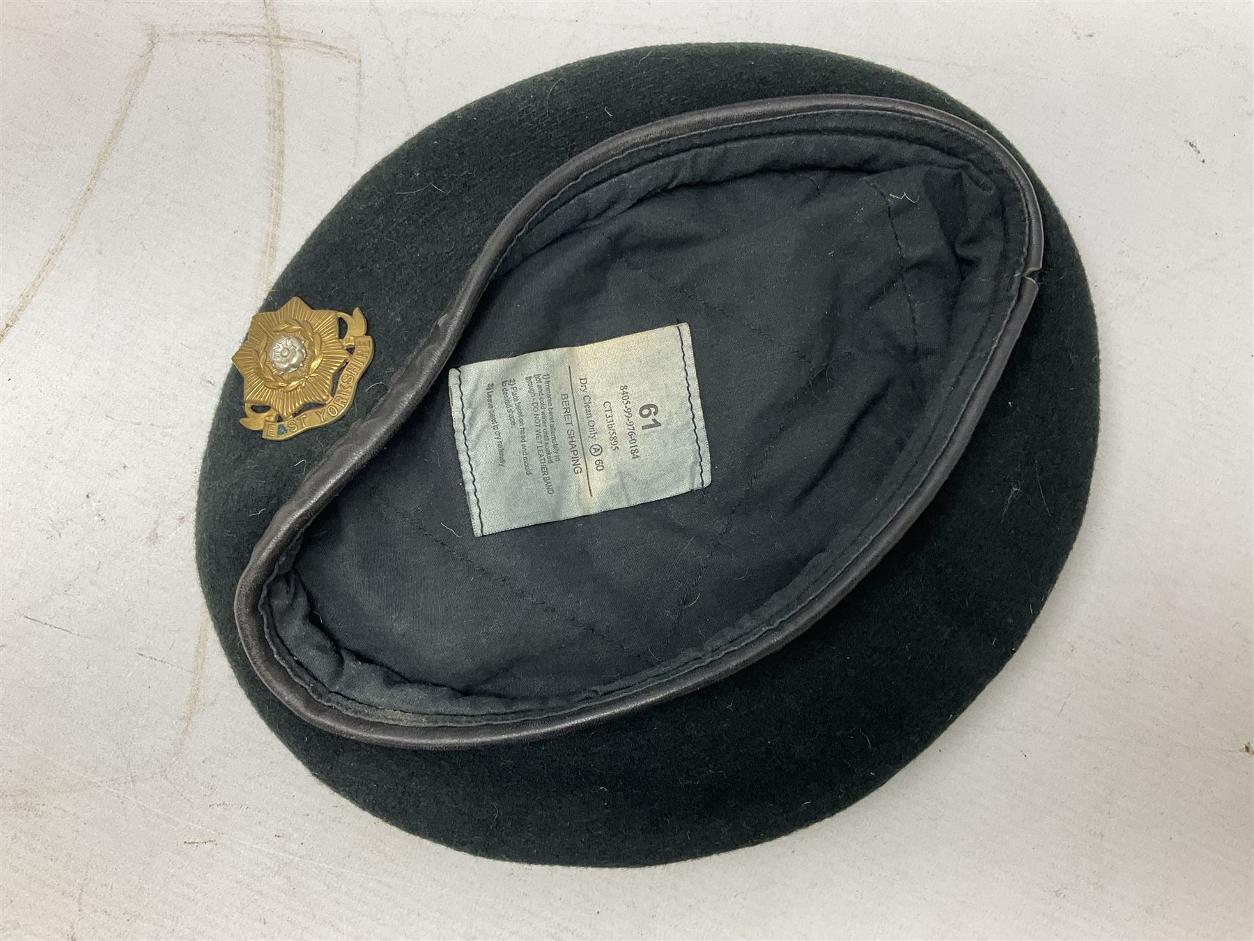 WW1 British Army Derby Scheme 1915 Attested armband; beret with East Yorkshire cap badge; pair of fur lined leather flying/motorcycle goggles; HMS Pembroke cap band; and small quantity of RNAS cloth and metal badges etc