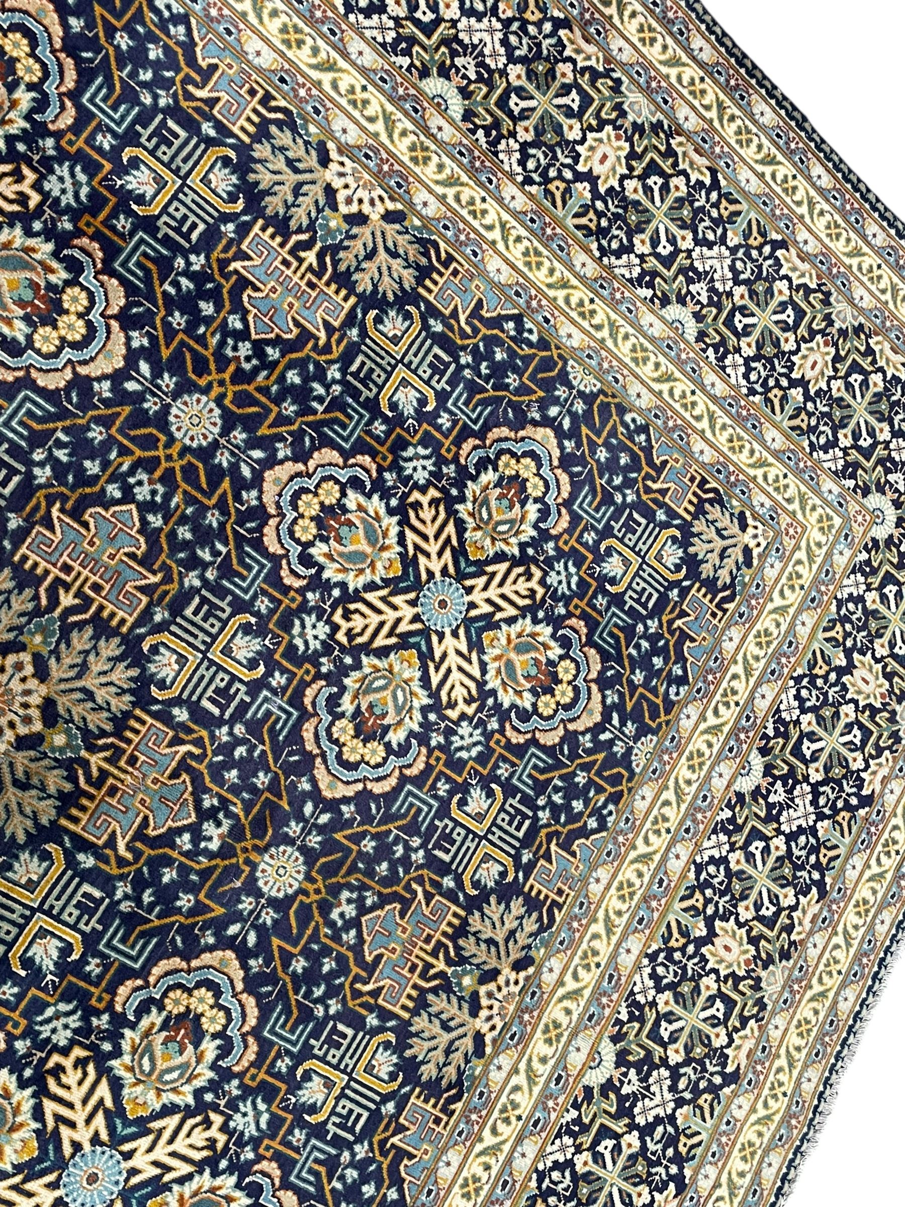 Persian indigo and pale gold ground rug, overall busy geometric design, the field decorated with hooked Hac and palmette medallions surrounded by densely patterned zig-zags and stylised foliate motifs, the border decorated with smaller Hac motifs, within multiple guard stripes 