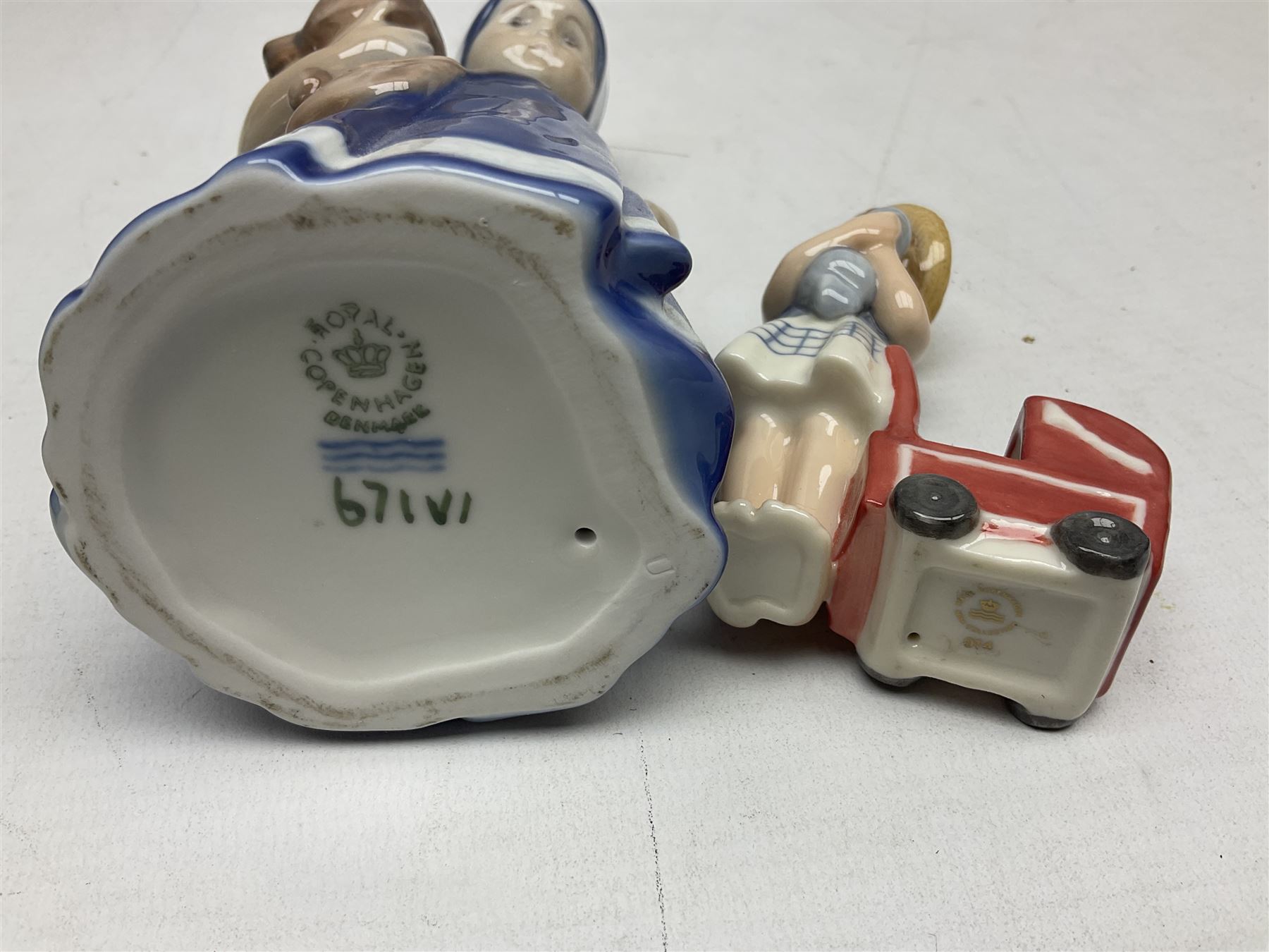 Four Royal Copenhagen figures, comprising Else with teddy no. 671, Snowman no. 158, Elsa no. 404, an mini collection girl with pram no.014, all with mark beneath  