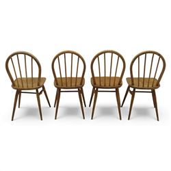 Ercol - Windsor dining chairs, set of four, each with rounded hoop back and four stick spindles, shaped elm seats with exposed plugs, raised on splayed beech tapering legs