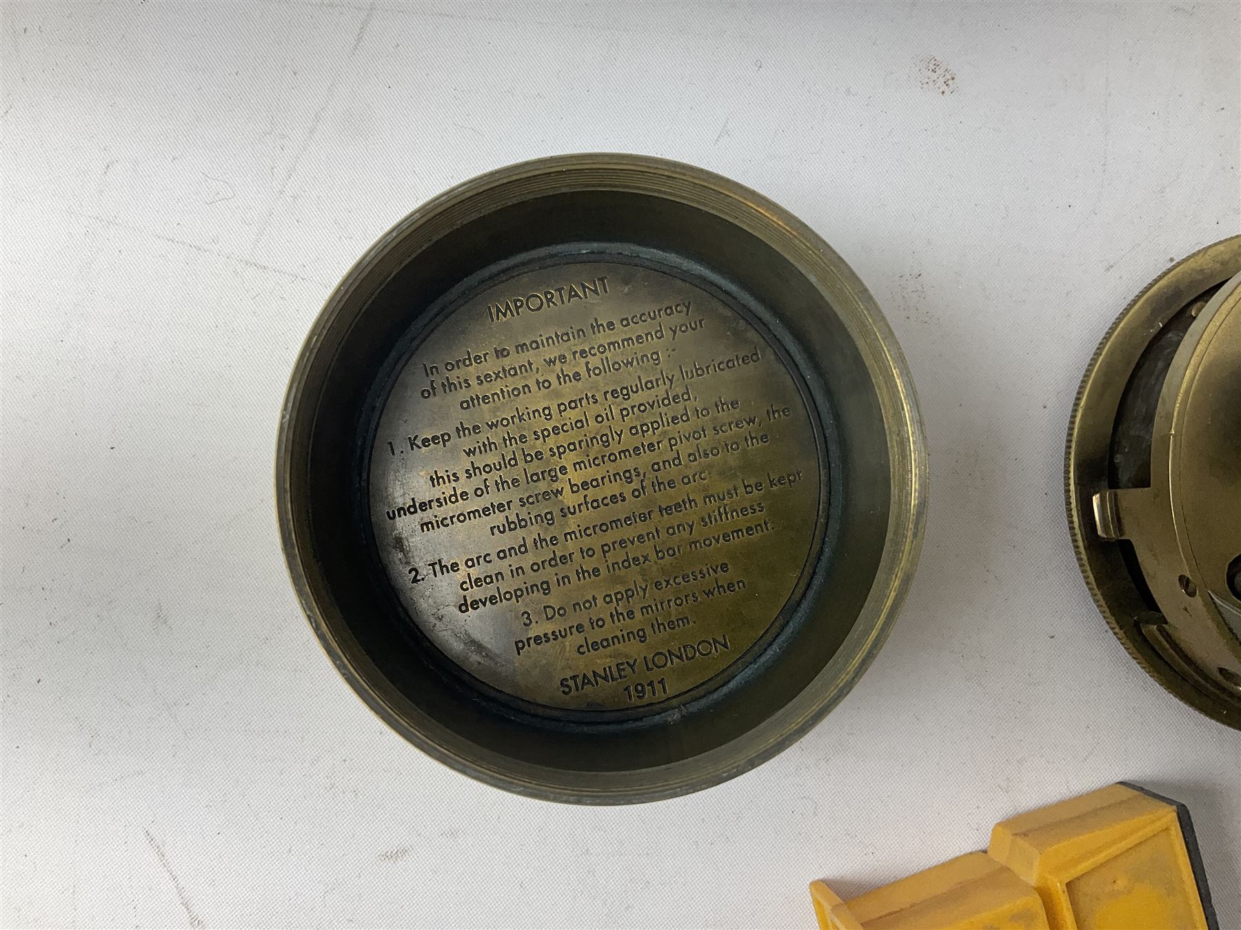 George VI 1937 Coronation flag, the central portrait and date covered with stitched panels 56 x 83cm; sailor's hat; leather holster with belt dated 1943 containing Lone Star toy die-cast Luger gun; and reproduction Stanley brass cased pocket sextant (4)