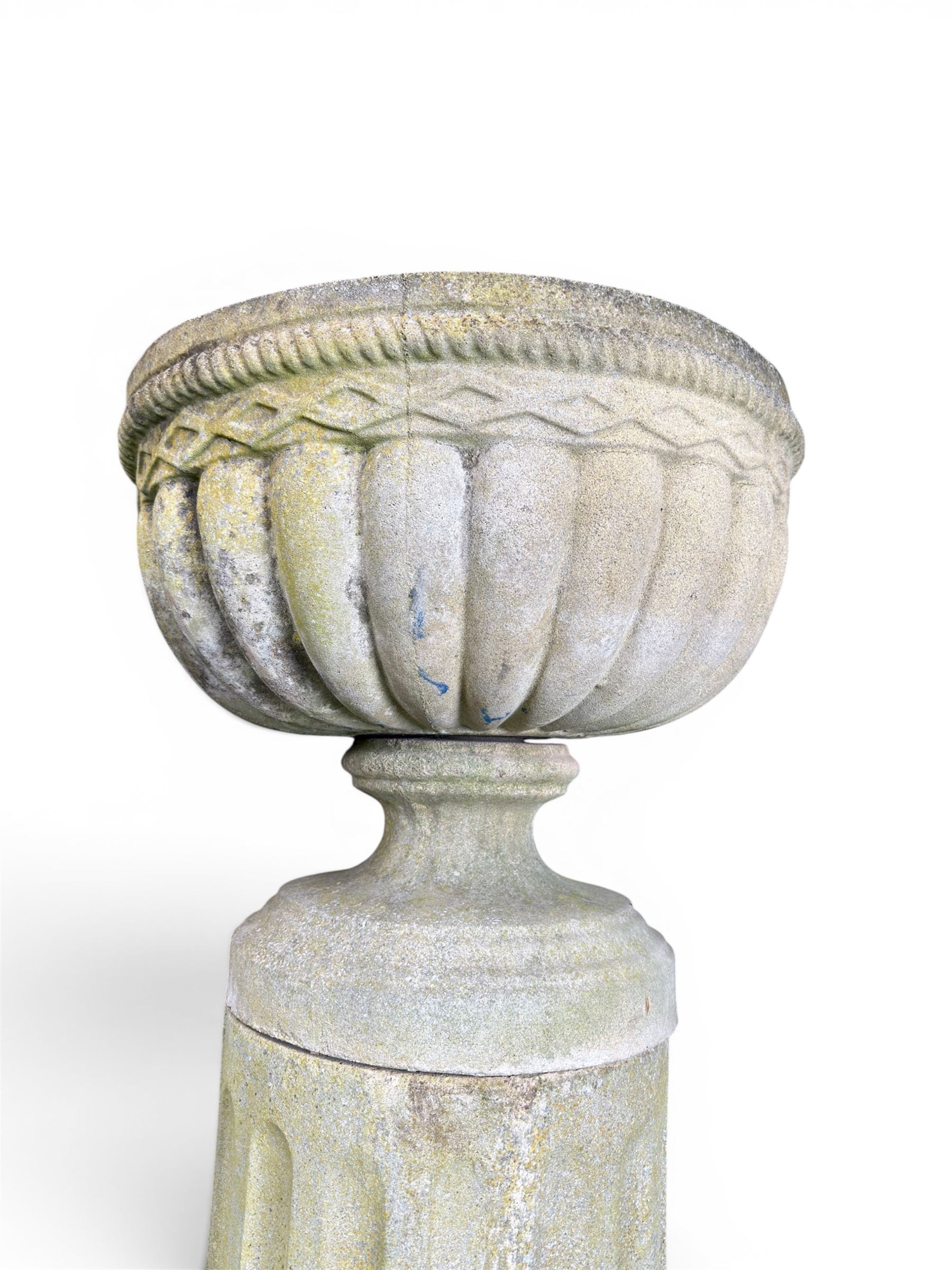 Four 20th century good quality weathered cast stone pedestal urns, circular lobed bowls with rope twist and lattice border, raised on squat base with fluted columns