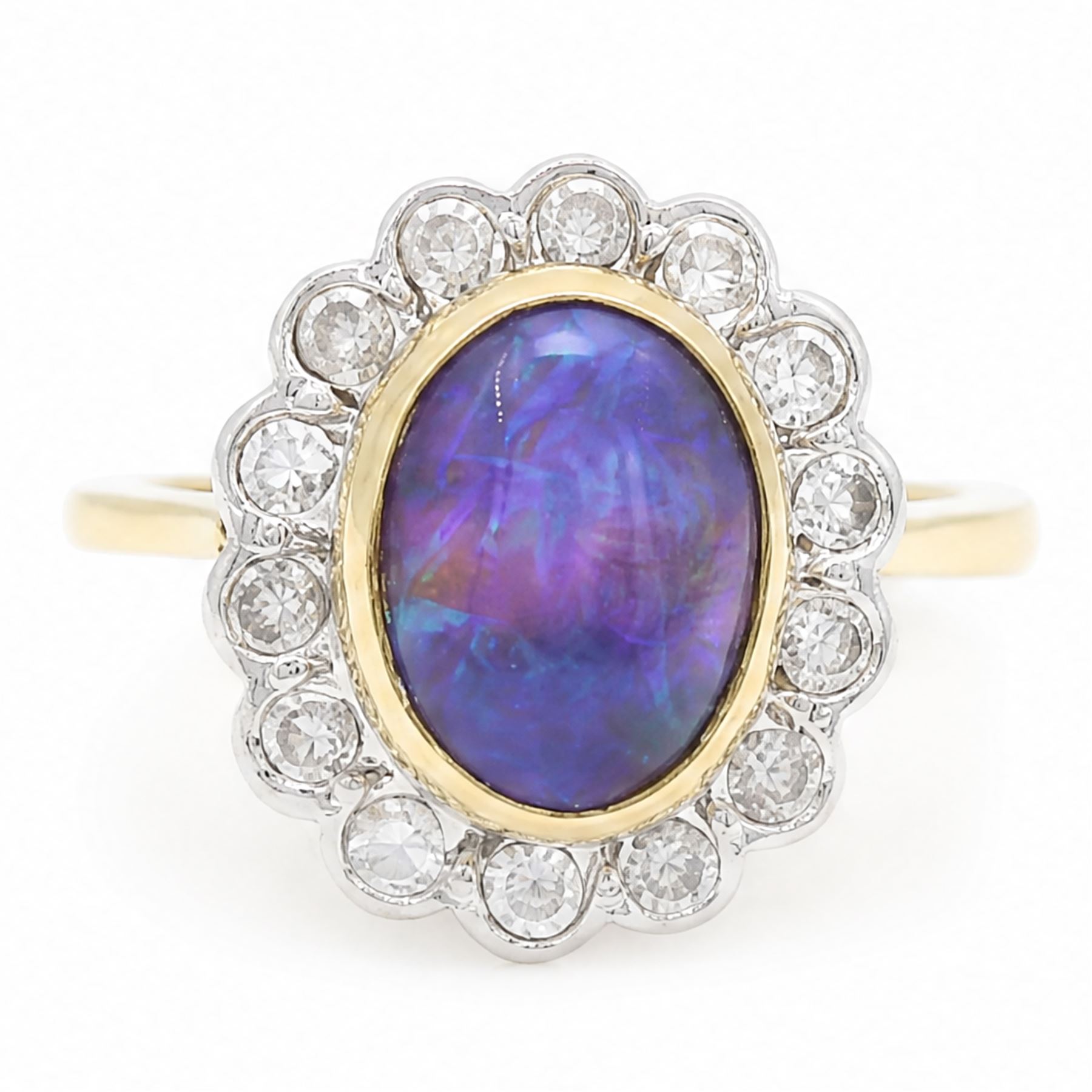 18ct gold black opal diamond cluster ring, single oval cabochon cut opal of 2.76 carat, surrounded by fourteen round brilliant cut diamonds, London 1998, total diamond weight 0.60 carat