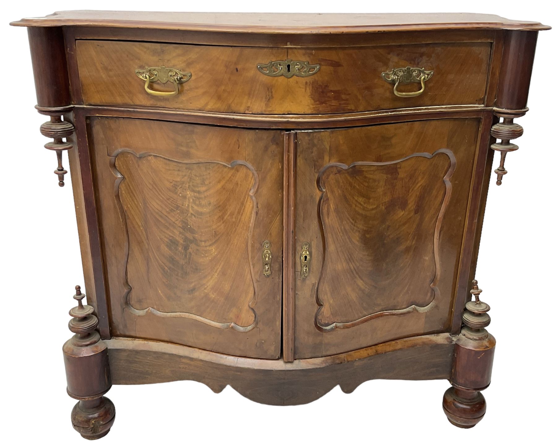 Victorian mahogany serpentine side cabinet, fitted with single drawer over panelled cupboard enclosing single shelf, raised on turned bun feet