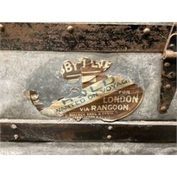 Early 20th century wood and metal bound zinc travelling trunk, hinged top with three clasps, decorated with period luggage labels