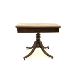 Regency mahogany pedestal table, fold over swivel top, raised on turned column to meet shaped supports and hairy paw brass castors 