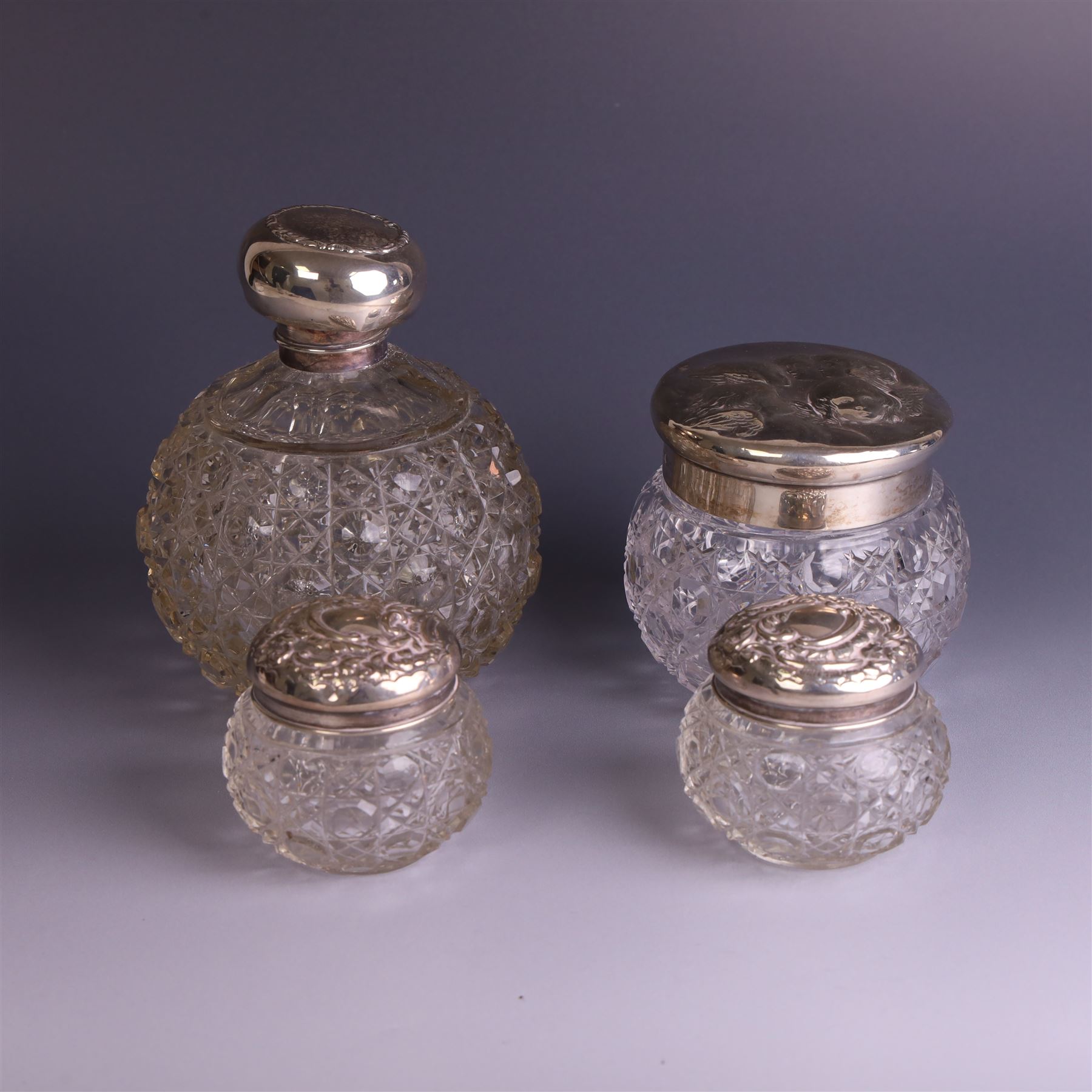 Early 20th century silver mounted cut glass scent bottle, with silver lid and three cut glass dressing table jars with silver lids, all hallmarked 