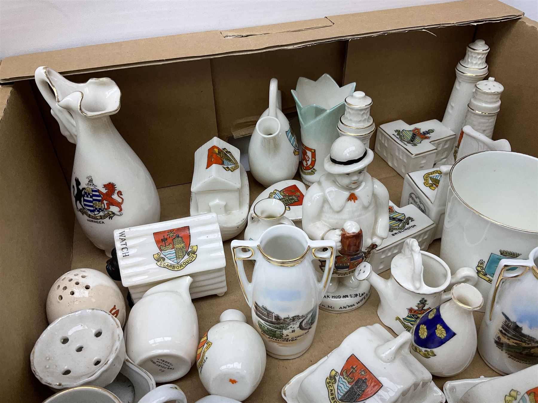 Collection of crested ware, to include Scarborough Willow Art coal truck, Whitby Willow Art Burns and Highland Mary figure group, Carlton China beer drinker 'Tak Hod an Sup Lad', and 'Here's ta me an'ma wife's usban', lighthouse, boat, Kingsway Art China Sir Walter Scott's Chair, butter dishes, candlestick, pianos etc