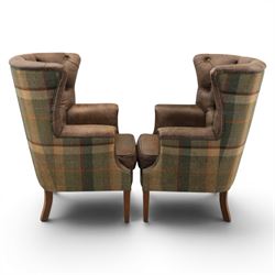 Pair of Georgian design wingback armchairs upholstered in brown leather and tartan tweed fabric, button back and scrolled arms with brass studded trim, square tapered supports
