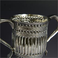 George III silver twin handled trophy cup, of typical form with twin C scroll handles and upon a domed circular foot, the body with repousse and chased fluting and C scroll decoration, with later presentation engraving to cartouche, hallmarked London 1803, maker's mark slightly rubbed but probably for Peter, Ann and William Bateman, H16cm