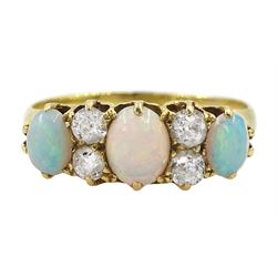 Early 20th century 18ct gold three stone opal, the centre stone set with two old cut diamonds either side, London 1913, total diamond weight approx 0.30 carat