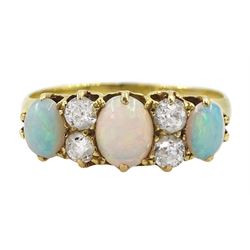 Early 20th century 18ct gold three stone opal, the centre stone set with two old cut diamonds either side, London 1913, total diamond weight approx 0.30 carat