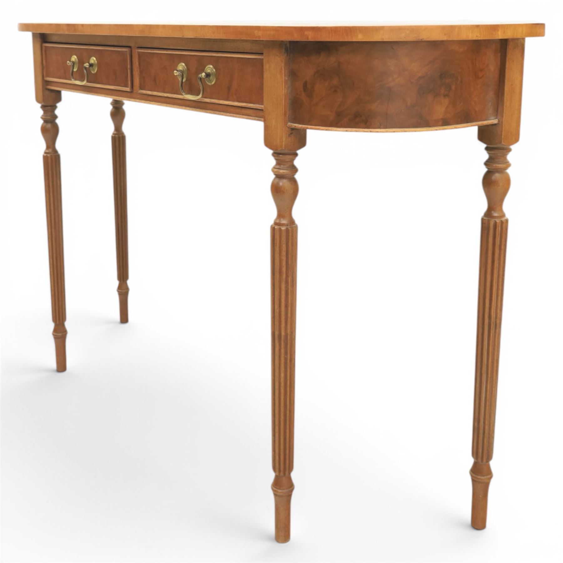 Traditional design walnut D-end hall table, figured top and sides, two frieze drawers with brass handles raised on fluted and turned supports