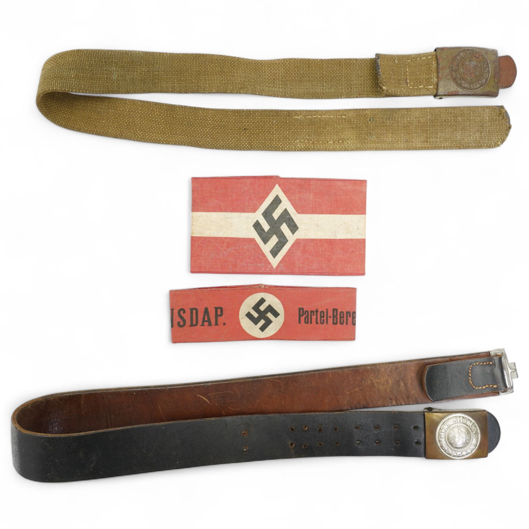 German WWI leather belt, the buckle marked 'Gott Mit Uns' surrounding a crown, a Third Reich webbing belt and buckle encircling eagle and swastika, NSDAP arm band and another