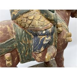 Large carved wood painted figure of warrior on horseback, decorated in red, blue and green, raised upon rectangular plinth base, H75cm W60cm