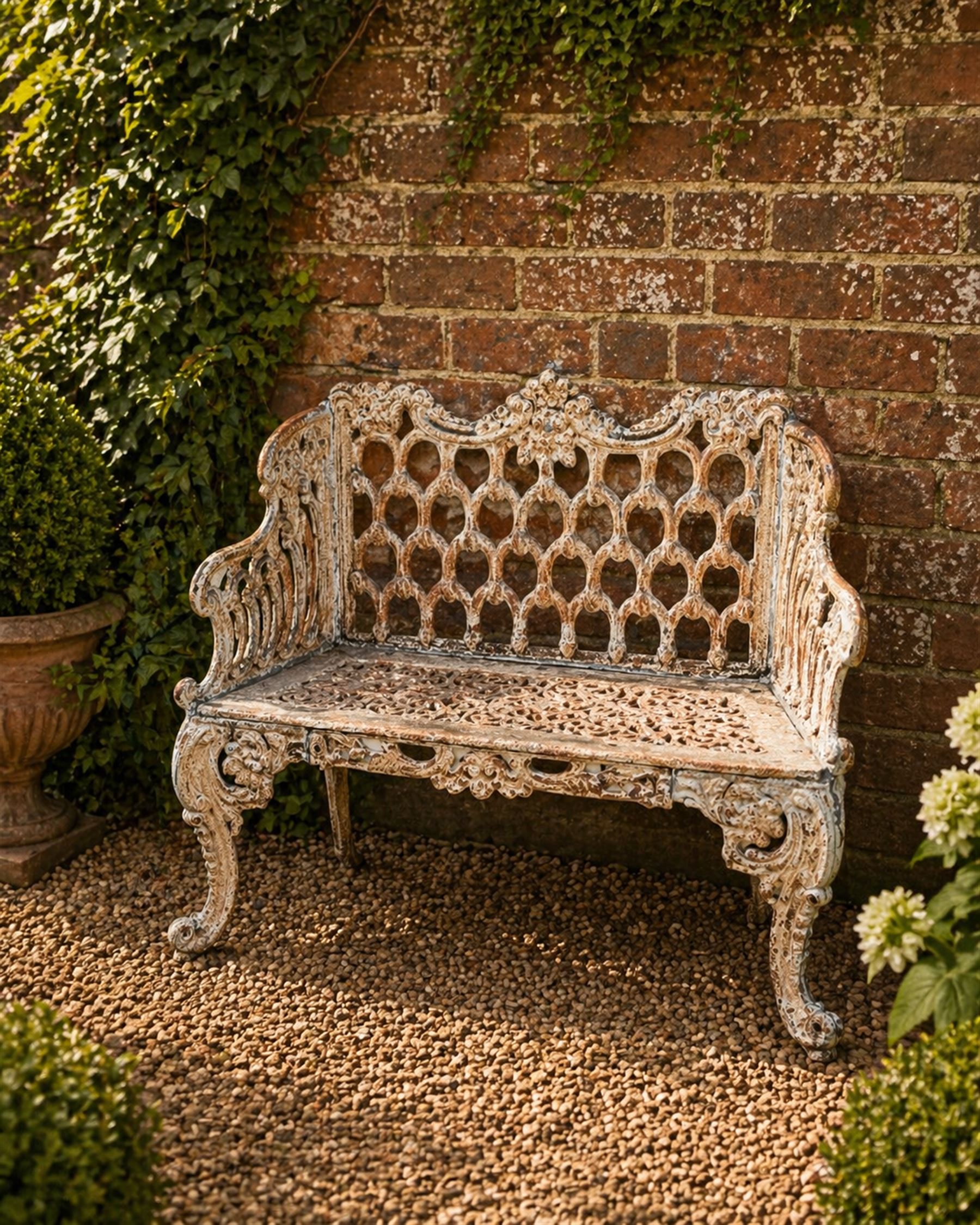 Victorian revival Carron Foundry design heavy cast iron two seat garden bench, scrolled arms with pierced lattice seat, finished in antique white paint
