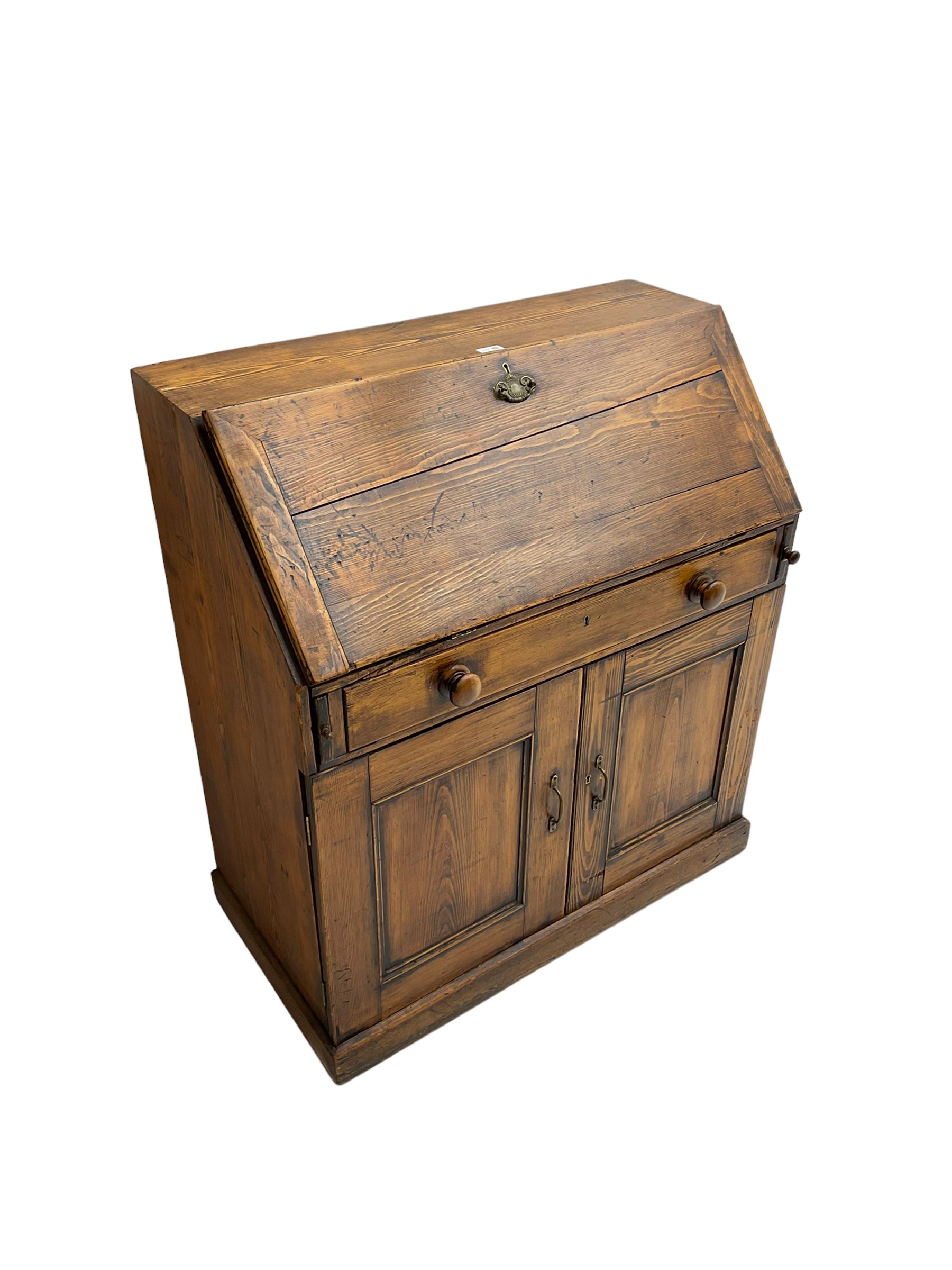 19th century waxed pine bureau, the fall front opening to reveal fitted interior with two drawers and five pigeonholes, base with single drawer over two panelled cupboard doors, on plinth base