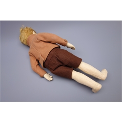  Lenci pressed felt boy doll, c1930, the swivelling head with blonde hair, painted side glancing brown eyes, smiling mouth with teeth, jointed body with stitched middle fingers, dressed in brown toned felt shirt, jacket and shorts H42cm  