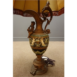  Large Italian gilt metal and moulded pottery table lamp in the form of a cherub mounted ewer with window lit shade, H101cm overall  