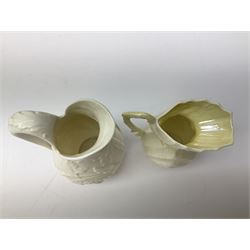 Quantity of Belleek ceramics to include mid-late 19th century jug moulded with green man mask and foliage, date code stamp for 1863-1890, together with later Belleek cornucopia shape vase, jug and other vases together with a Belleek style shell dish raised on branches, tallest H19cm