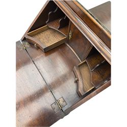 Small early 20th century Queen Anne style bookcase on bureau secretaire, the moulded arched pediment over mirrored door in shaped frame, the bureau fitted with fall front enclosing curved fitted interior, cushion moulded drawer over single drawer, on scroll and shell carved cabriole supports