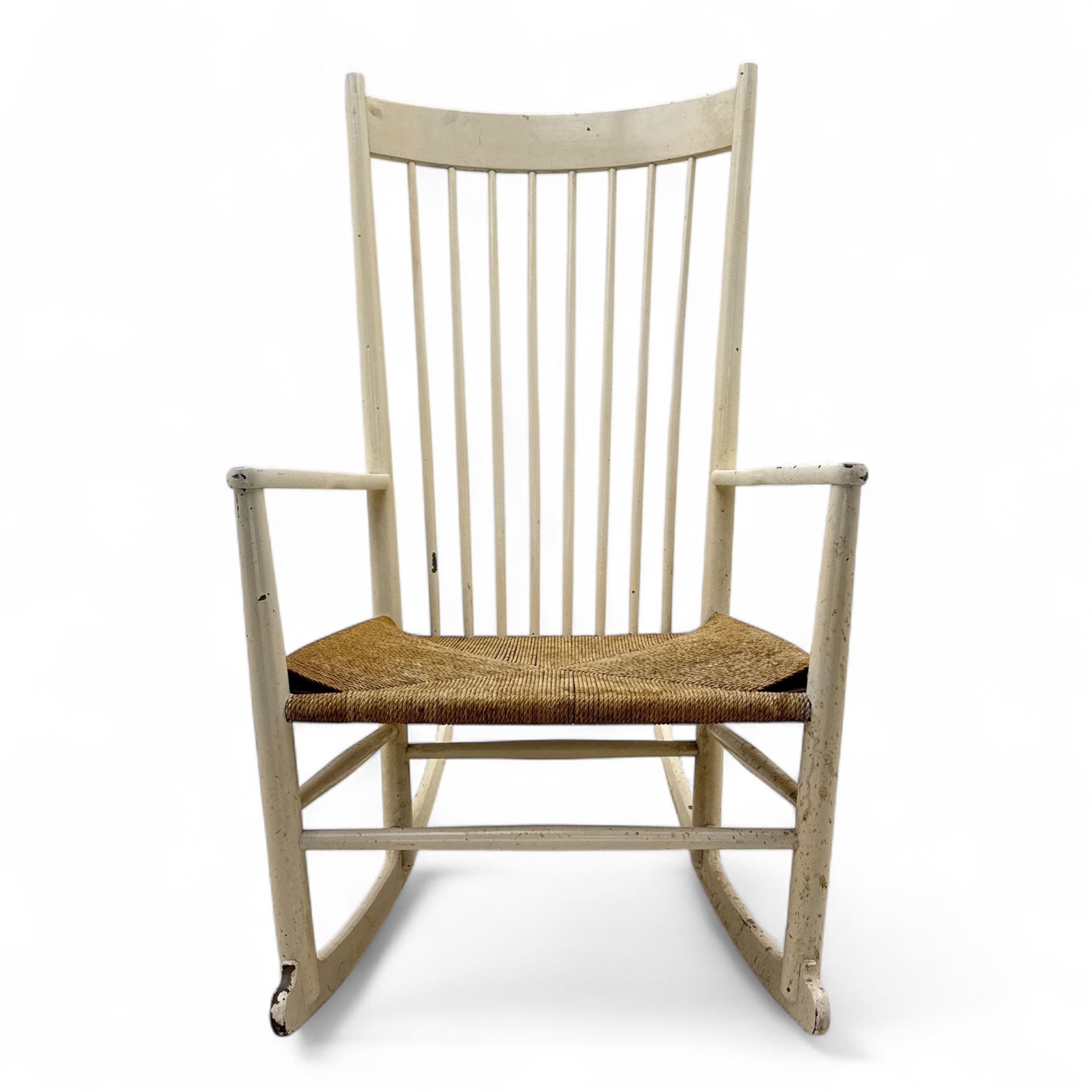 Mid-20th-century Scandinavian painted high-back rocking chair, curved top rail above slender spindle back, shaped arms with rounded ends above hand-woven rush seat, tapered rockers reinforced by turned stretchers 