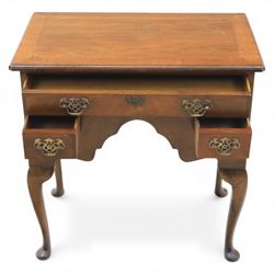 Early 20th century walnut lowboy in Queen Anne style, rectangular crossbanded top over single long drawer and two short drawers with shaped apron, fitted with brass drop handles and backplates, raised on cabriole supports terminating in pad feet