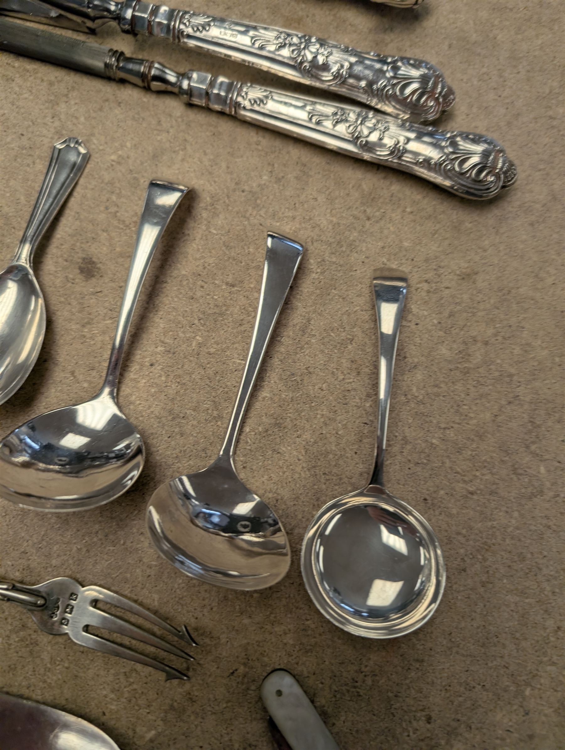 Group of silver and silver handled cutlery, including caddy spoons, thimble, propelling pencil, fruit knife, etc, all stamped or hallmarked