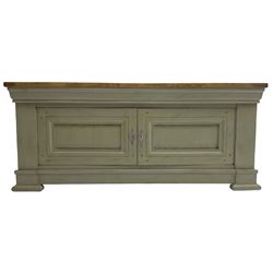 Painted oak side cupboard or television stand, rectangular oak top over two panelled cupboard doors, on stepped plinth base with compressed block feet, in washed laurel green paint and waxed finish
