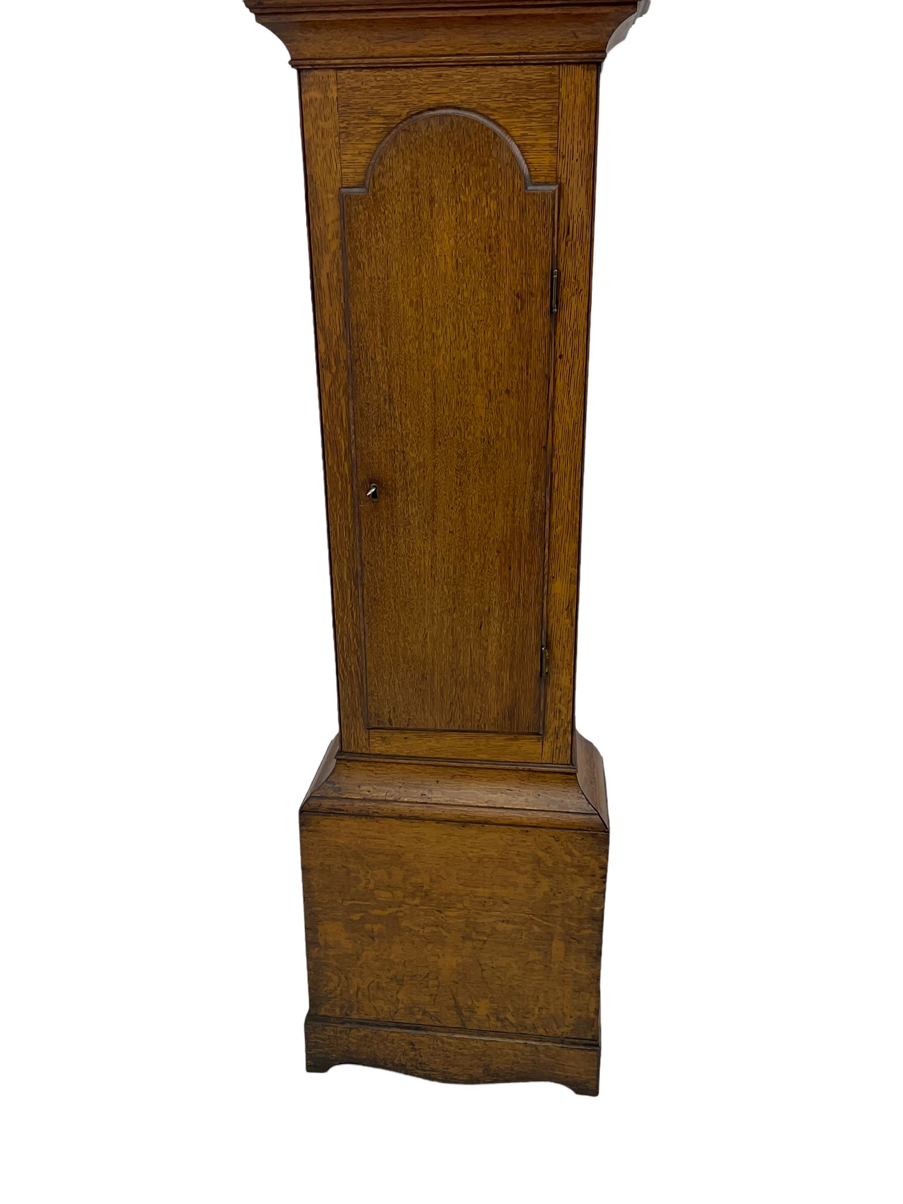 A provincial oak longcase clock retailed by “Geo Hunt, Amesbury” c1820, with a crested break arch pediment and corresponding glazed hood door flanked by two plain pillars with capitals, long trunk with a full length break arch door on a rectangular plinth with a shaped base, painted dial with Arabic numerals, minute markers, subsidiary date and seconds dials and stamped brass hands, matching painted spandrels and a depiction of sea shells to the arch, dial pinned to the movement via a Walker Hughes cast falseplate, with an eight day rack striking movement, striking the hours on a cast bell. With weights and Pendulum




