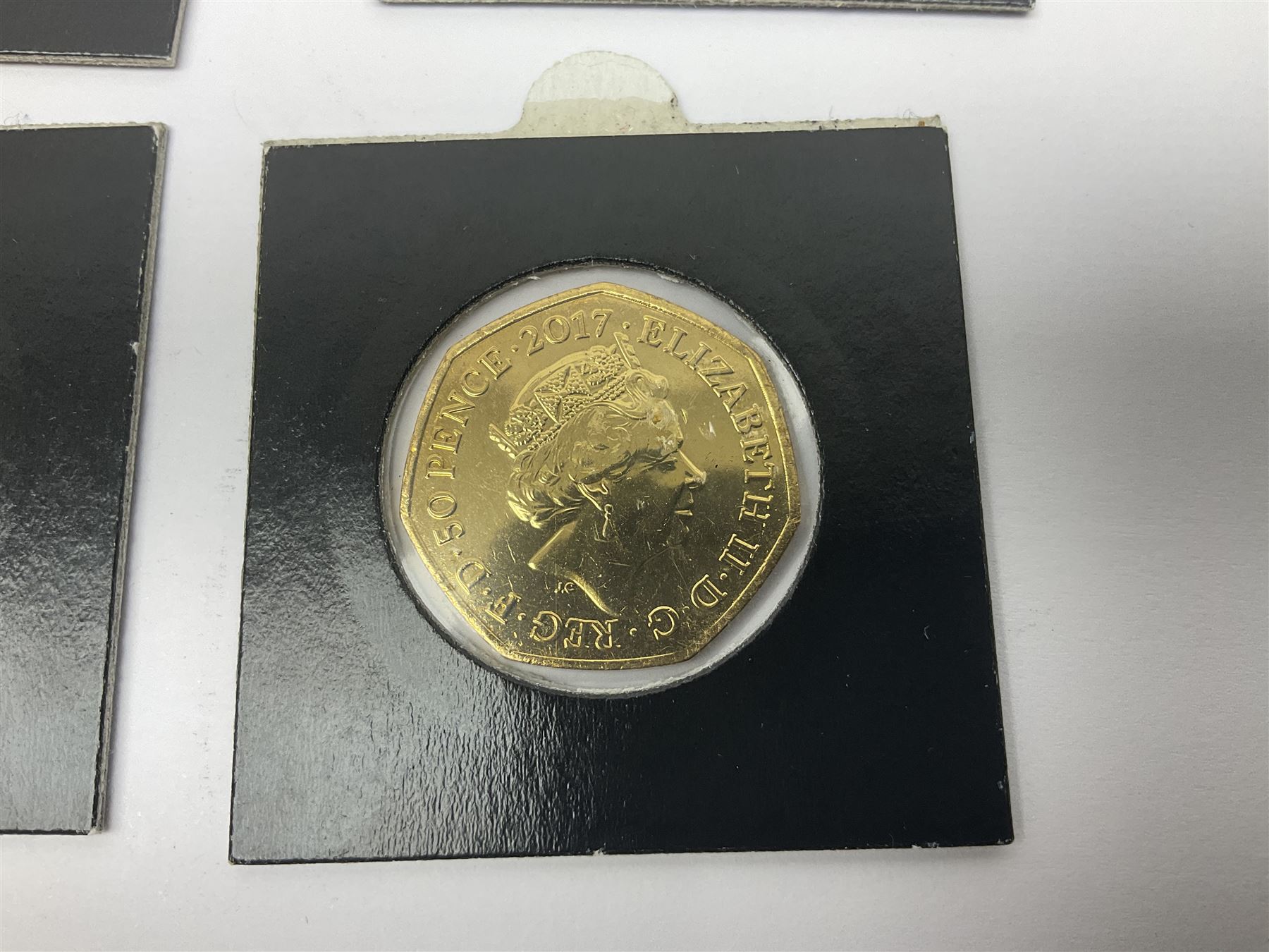 Four gold plated and coloured commemorative fifty pence coins, comprising 2017 Benjamin Bunny, Mr Jeremy Fisher, Tom Kitten and The Tale of Peter Rabbit, with Gold Strike certificate of authenticity