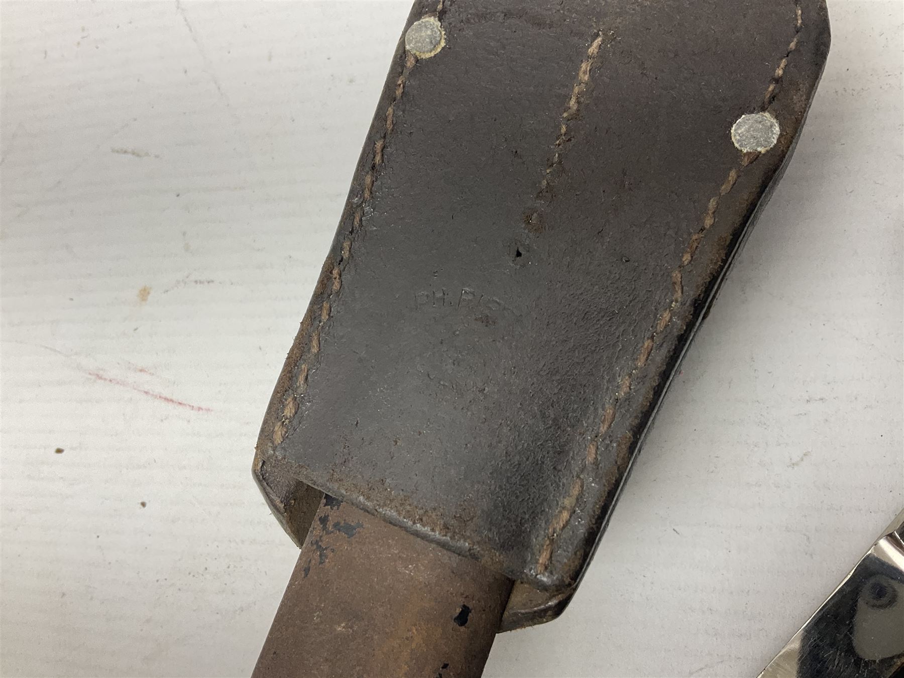 WWII German K98 (short) NCO dress bayonet, the 20cm fullered blade marked Anton Wingen Solingen to the ricasso, with chequered black grip plates; in steel scabbard with indistinctly stamped leather frog |L37cm overall