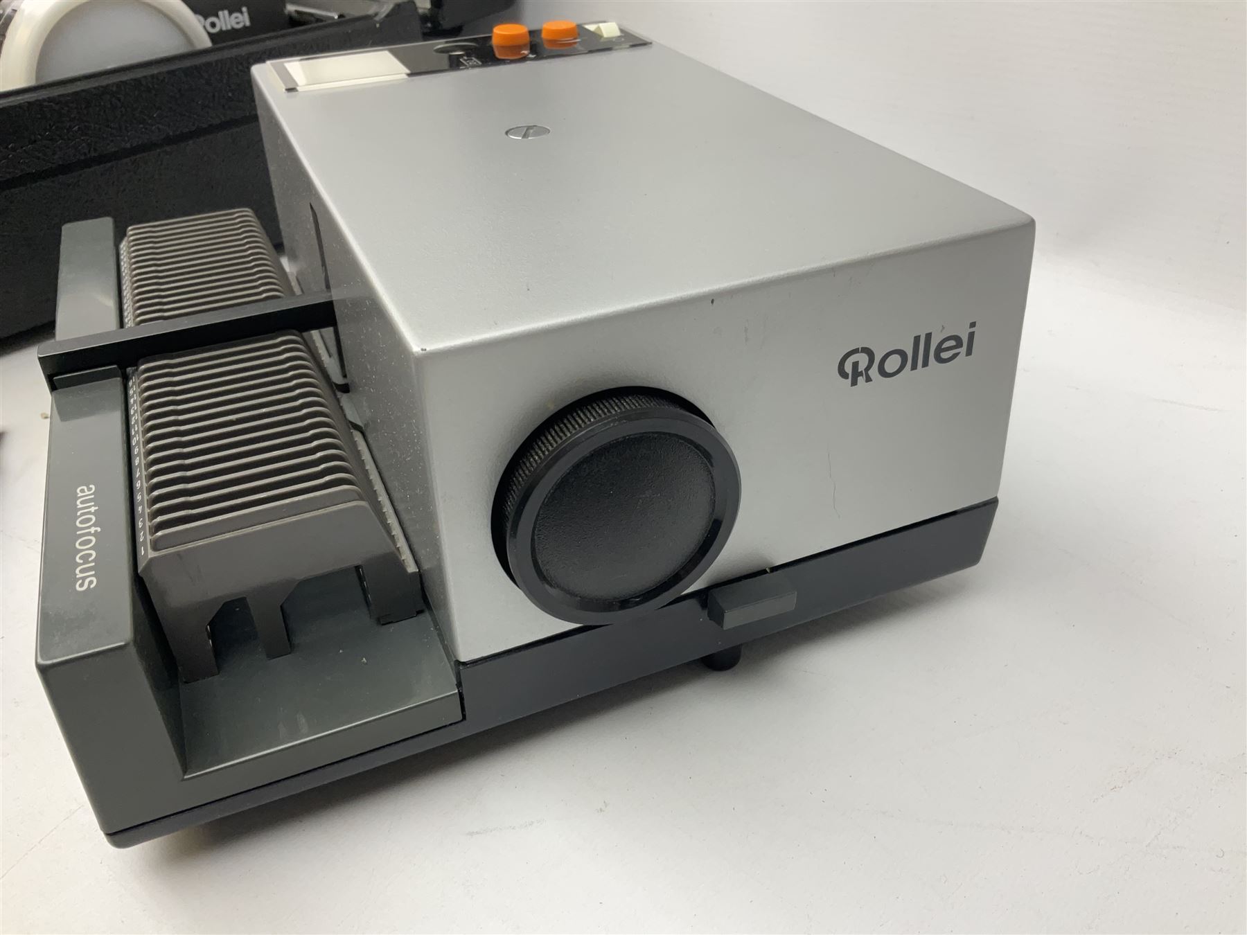 Cased Rollei projector together with a palar projector screen, autofocus slide projector and cenei scoper 360 