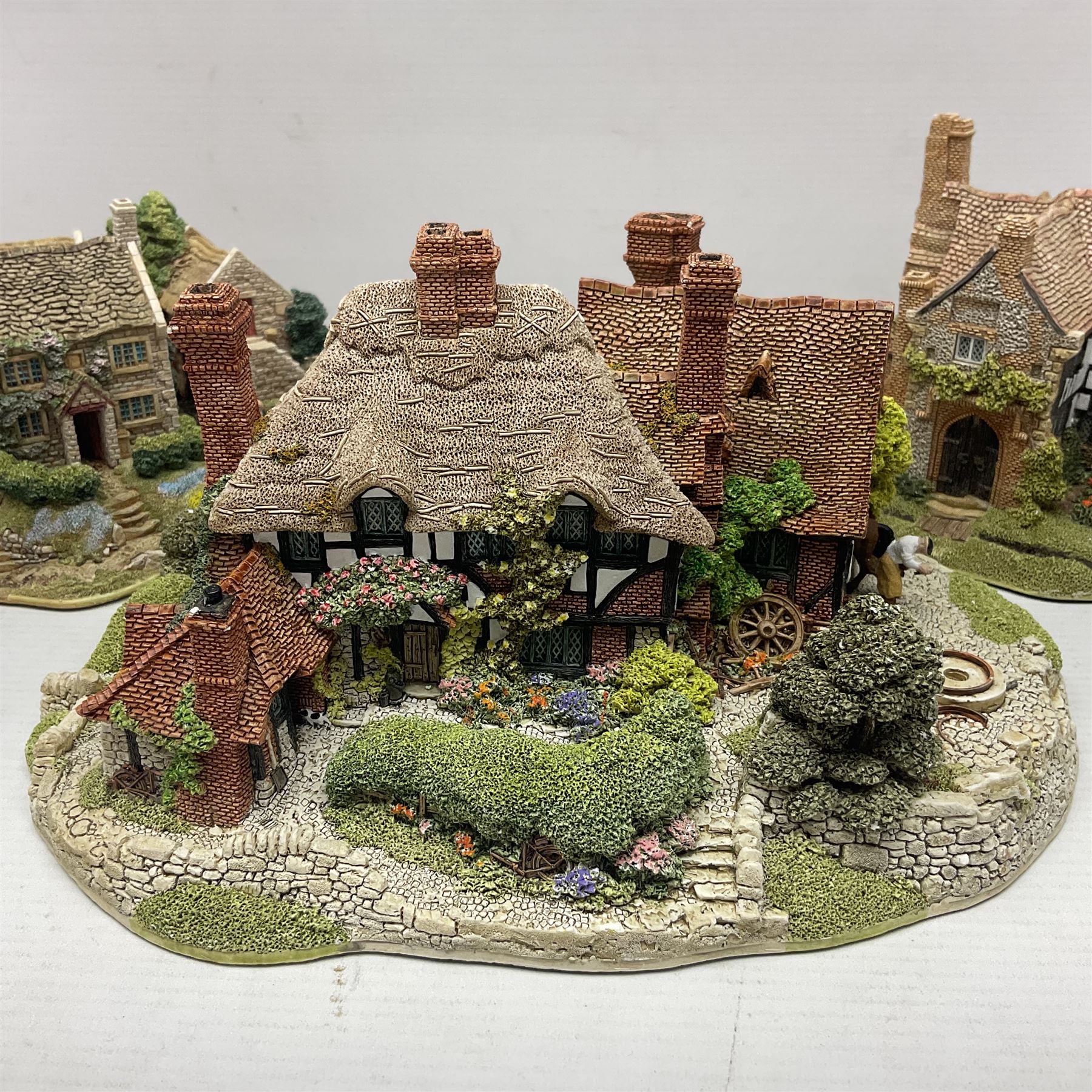 Three Lilliput lanes, comprising Oakwood Smithy, Anne of Cleves and Bluebell Farm, all with deeds and original boxes 