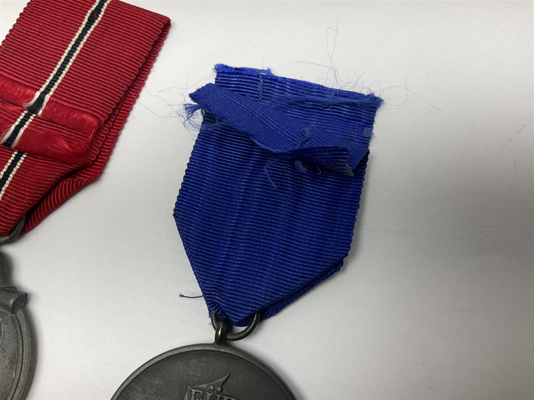 WWII German 'SS' Long Service Medal for four years; Ostfront Medal for the Winter Campaign in Russia of 1941-1942 'Die Medaille Winterschlacht Im Osten'; and War Merit Cross 2nd Class with swords; all with ribbons (3)