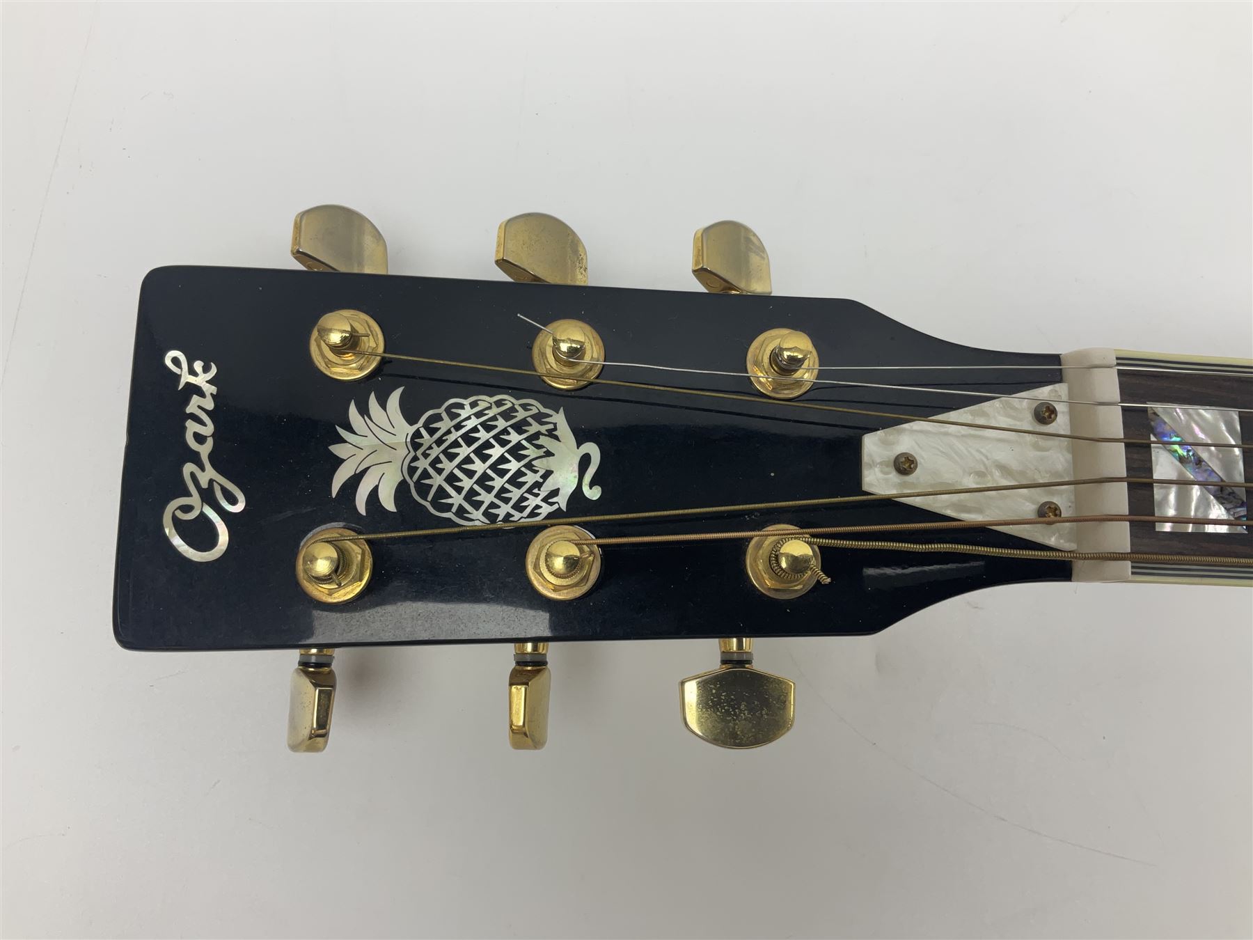 Ozark metal cased resonator guitar with all over chased foliate decoration to the polished finish and mother-of-pearl inlay to the fretboard L100cm; in Stagg hard carrying case