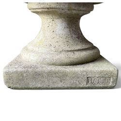 Regency design weathered cast stone garden urn of kylix form, the anthemion and arrowhead moulded everted rim over a fruiting laurel and lion-mask relief decorated body, waisted socle on square base, stamped HGC