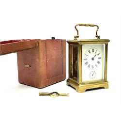 Early 20th century brass and bevel glazed carriage alarm clock, white enamel Roman dial with alarm set dial, single train movement, with red leather case 