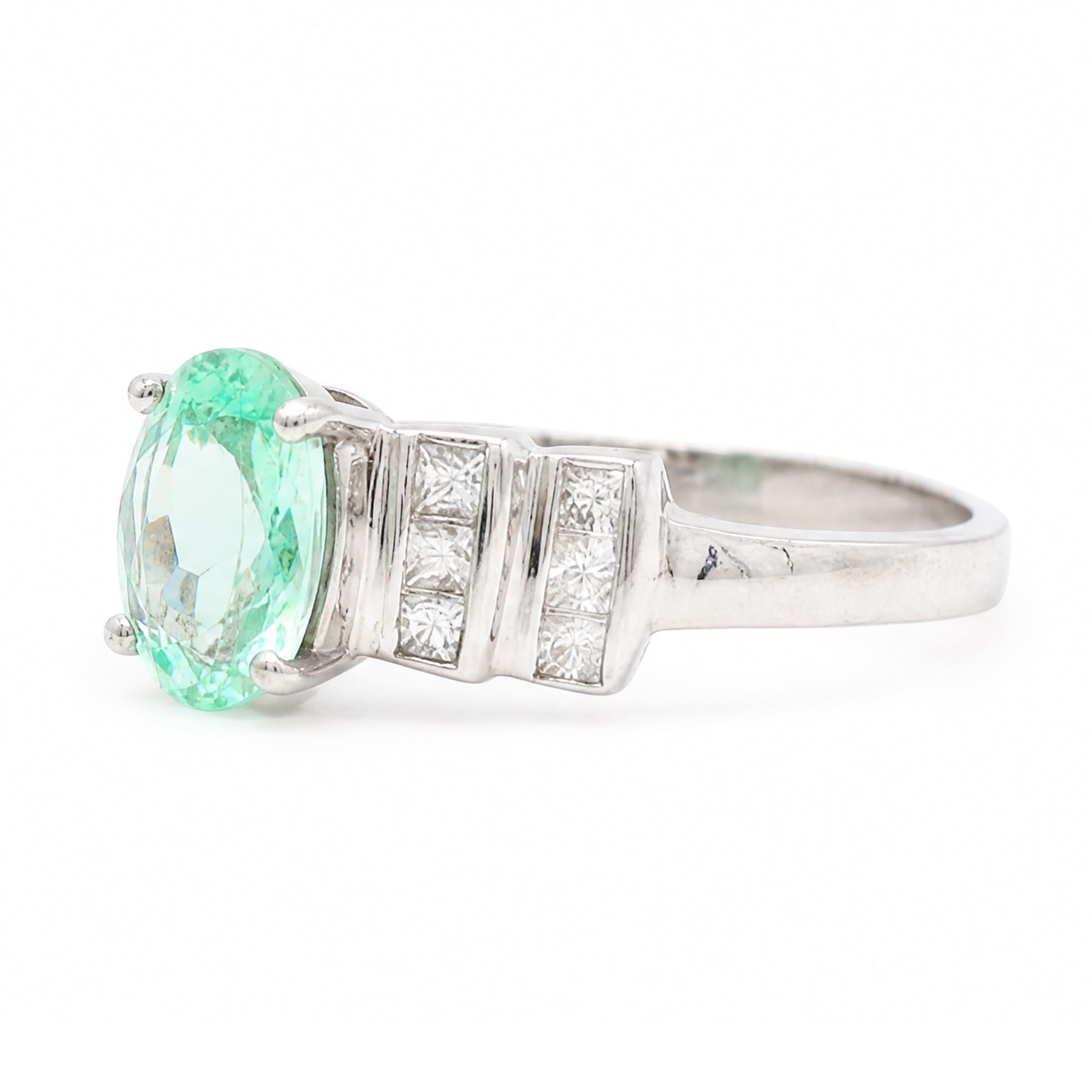 18ct white gold Paraiba tourmaline and diamond ring, single oval cut tourmaline of approx 0.90 carat, with six princess cut diamonds either side, in a stepped design setting, hallmarked, total diamond weight approx 0.35 carat