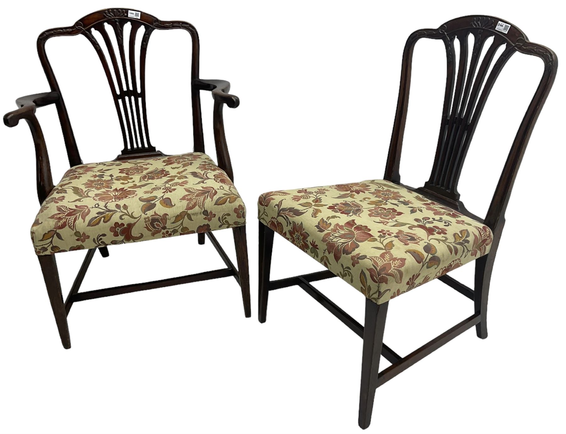 George III Hepplewhite design mahogany elbow chair and matching side chair, cresting rail carved with bellflowers over pierced and flared splat, seats upholstered in floral patterned fabric, raised on square tapering supports united by stretchers