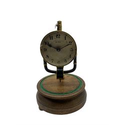 A 1920’s French 800-day Bulle electric battery clock on a turned wooden base, with a circular silvered dial with Arabic numerals, minute track and steel spade hands, skeletonised brass movement and escapement, the magnetic pendulum action is activated by the battery power source located in the base of the clock. No Dome.