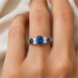 Early 20th century gold sapphire and diamond ring, three vari-cut sapphires, spaced by four old cut diamonds, with scroll design shoulders, stamped 18ct, total sapphire weight approx 1.45 carat, total diamond weight approx 0.30 carat