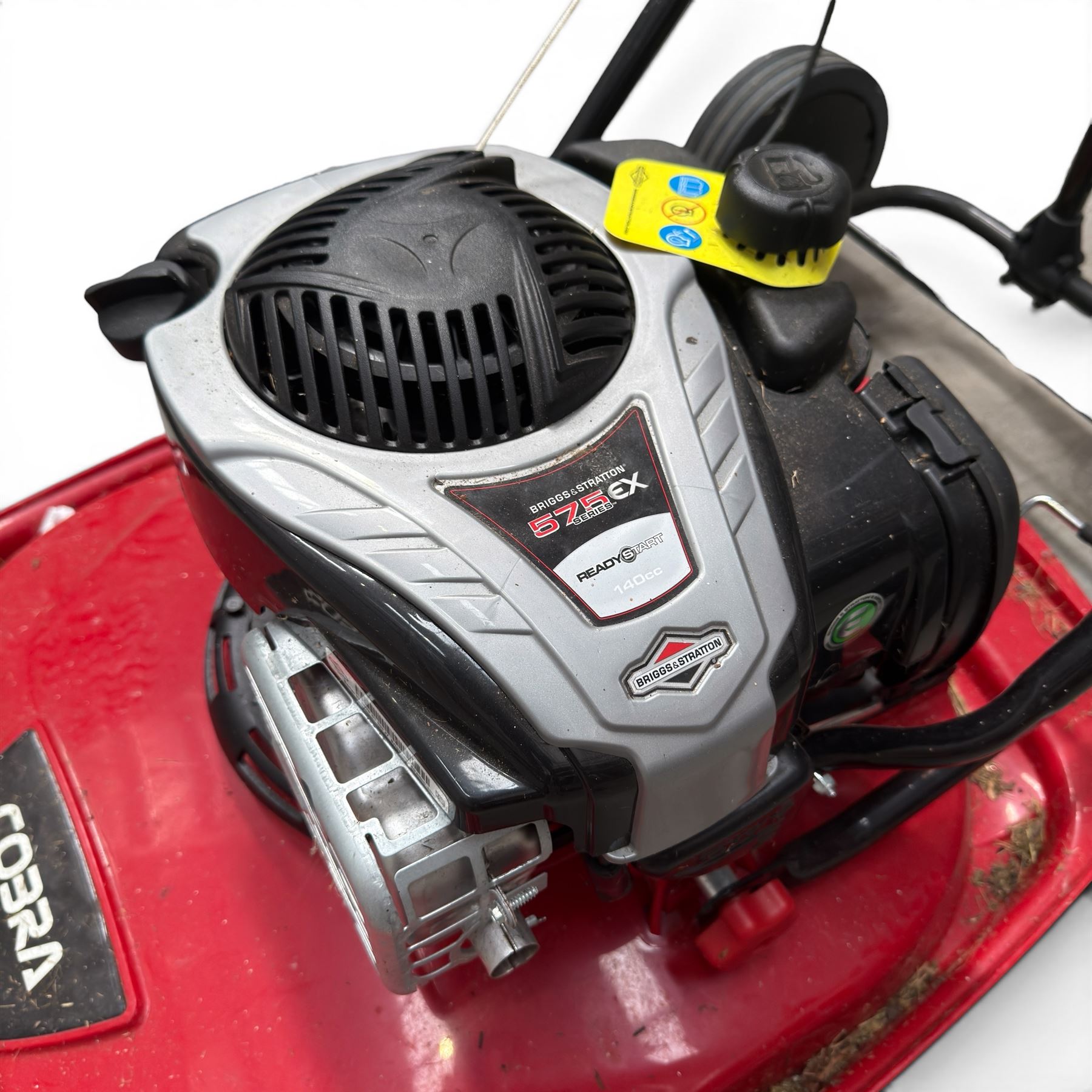 Cobra-  575ex petrol hover mower, with Briggs & Stratton engine, wheeled transport frame and red deck.