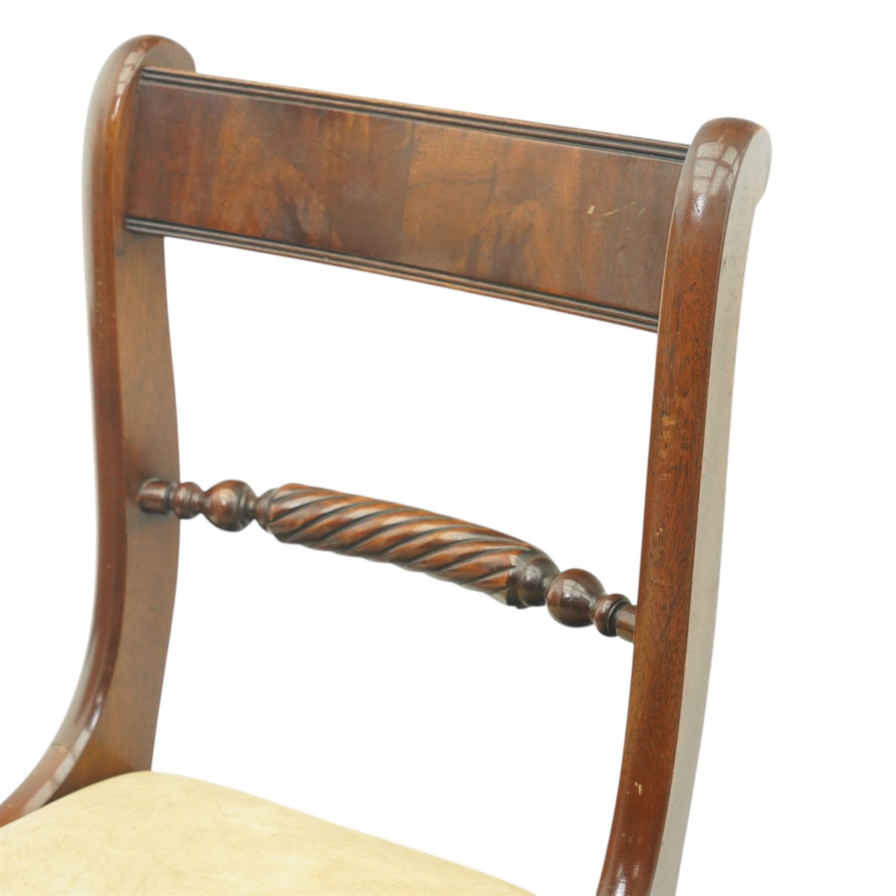 Late 20th century Regency style mahogany dining chairs, set of four, bar backs with figured veneered top rails and turned spindle stretchers, drop-in seats upholstered in beige leather, on moulded sabre supports