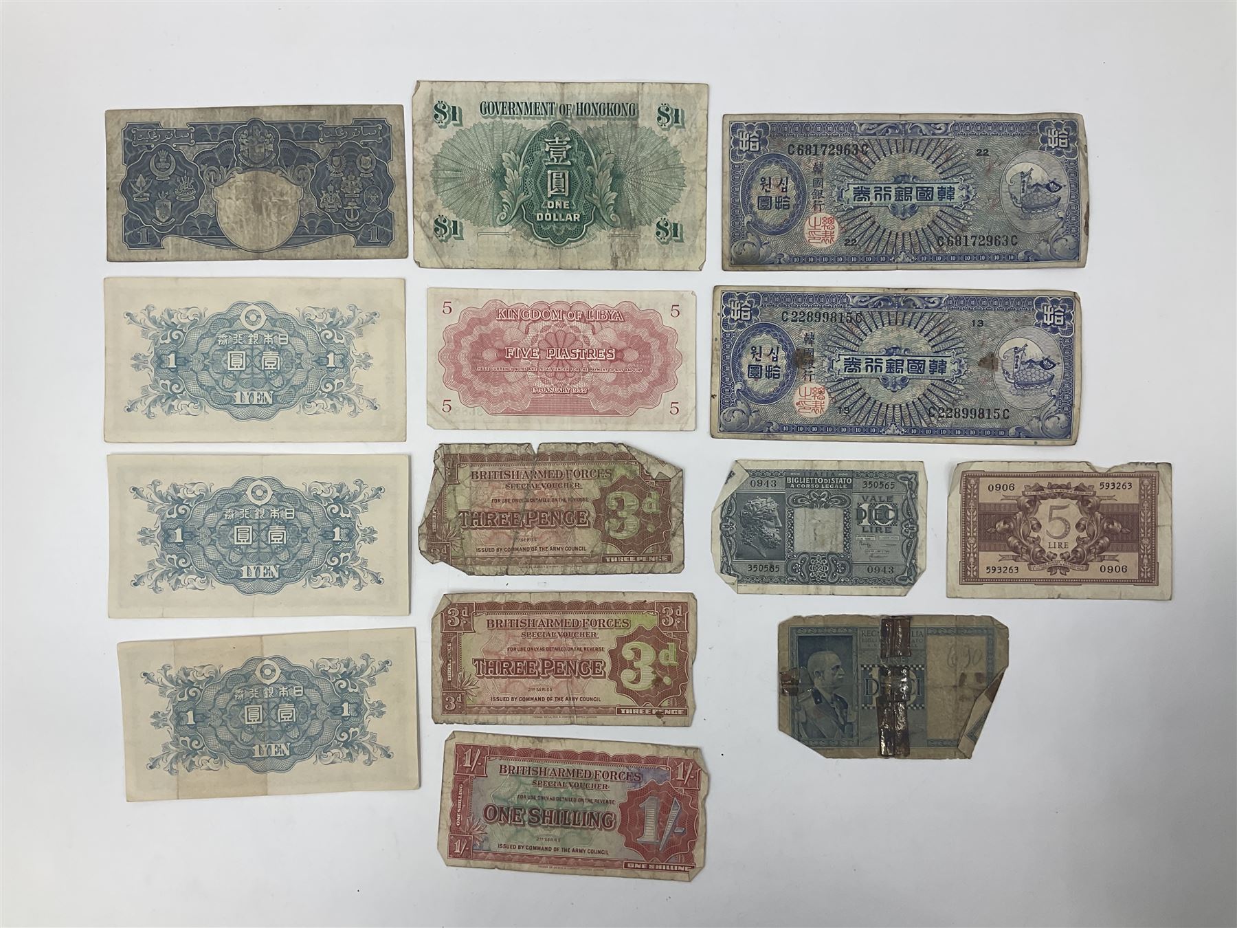 Banknotes including King George VI board of commissioners of currency Malaya one dollar 1st July 1941 'P/59 030908', Queen Elizabeth II Government of Hongkong one dollar 1st July 1952 'F/6 202153' etc