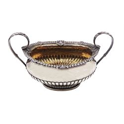 George III silver twin handled sucrier, of part fluted oval form with oblique gadrooned rim with shell and palmette cast detail, twin acanthus mounted curved handles and gilt interior, hallmarked Paul Storr, London, date letter worn and indistinct, including handles H12.5cm bowl L17cm, approximate weight 15.44 ozt (480 grams)